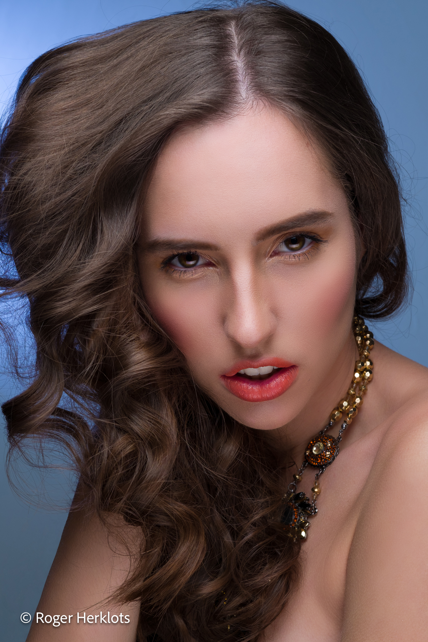 Portrait: woman in studio with natural lighting, confident expression