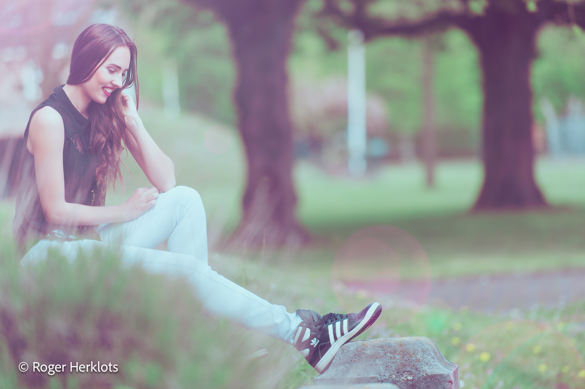 Lifestyle: woman in flowing dress on sunlit terrace at golden hour