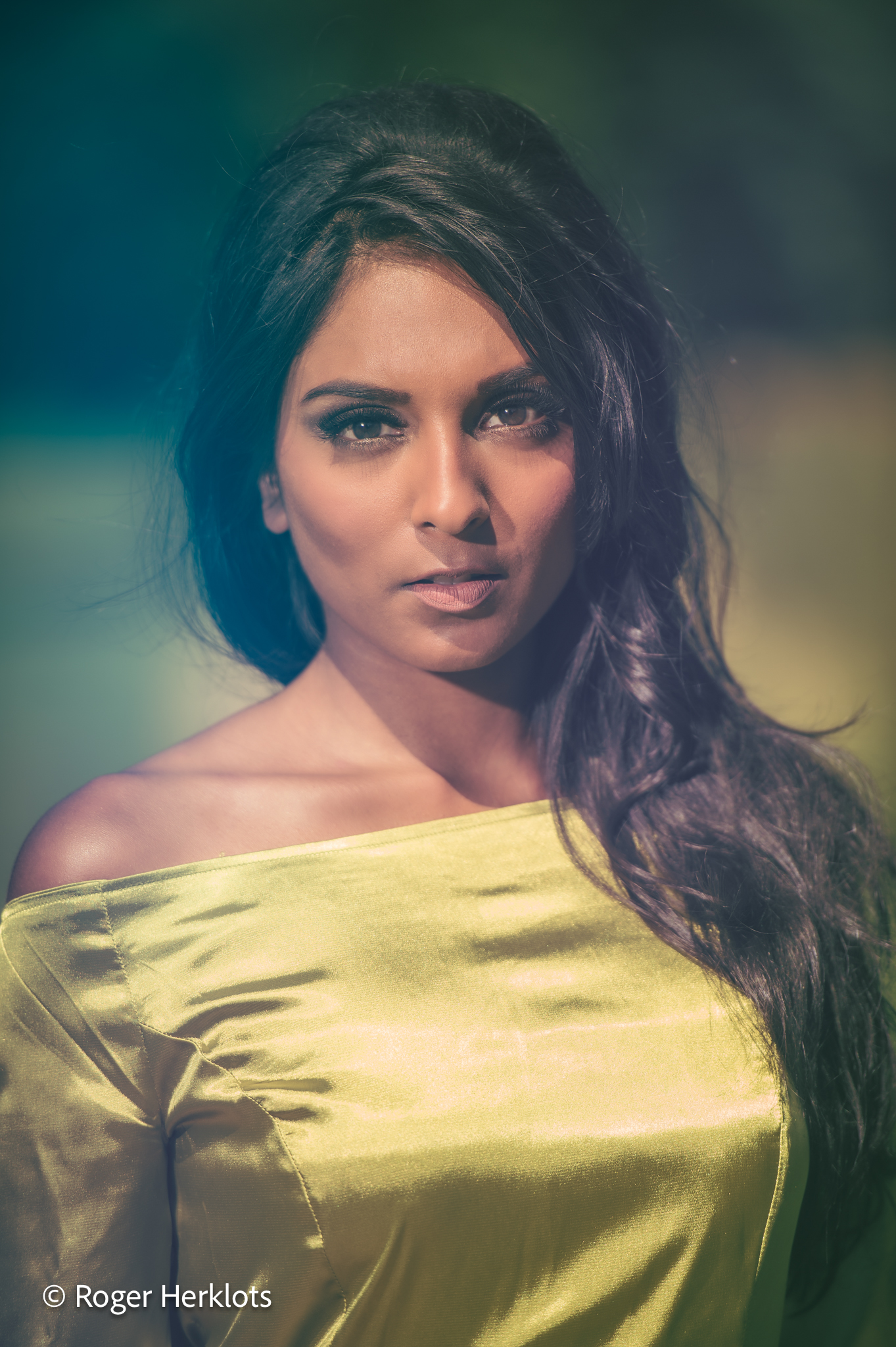 Fashion: glamorous woman with beaded evening gown in studio